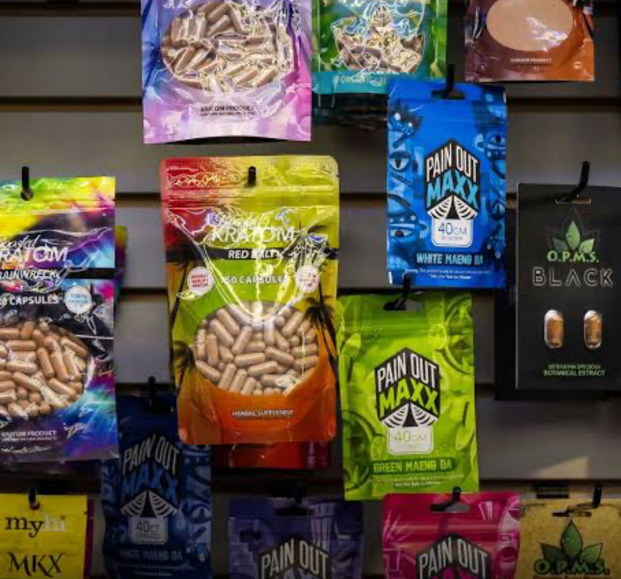 Kratom capsules in colorful bags on display in a store